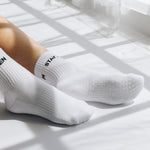 White  grip socks with text Stay Zen on a light surface
