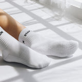 White  grip socks with text Stay Zen on a light surface