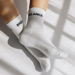 White grip socks with text balance/breathe on a light background
