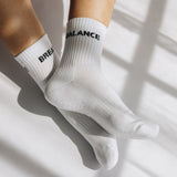 White grip socks with text balance/breathe on a light background