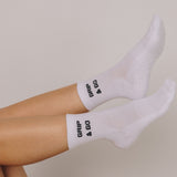 White grip socks with 'Grip & Go' branding on a neutral background