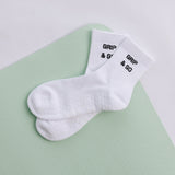 White grip sock with 'Grip & Go' branding on a light green and white background