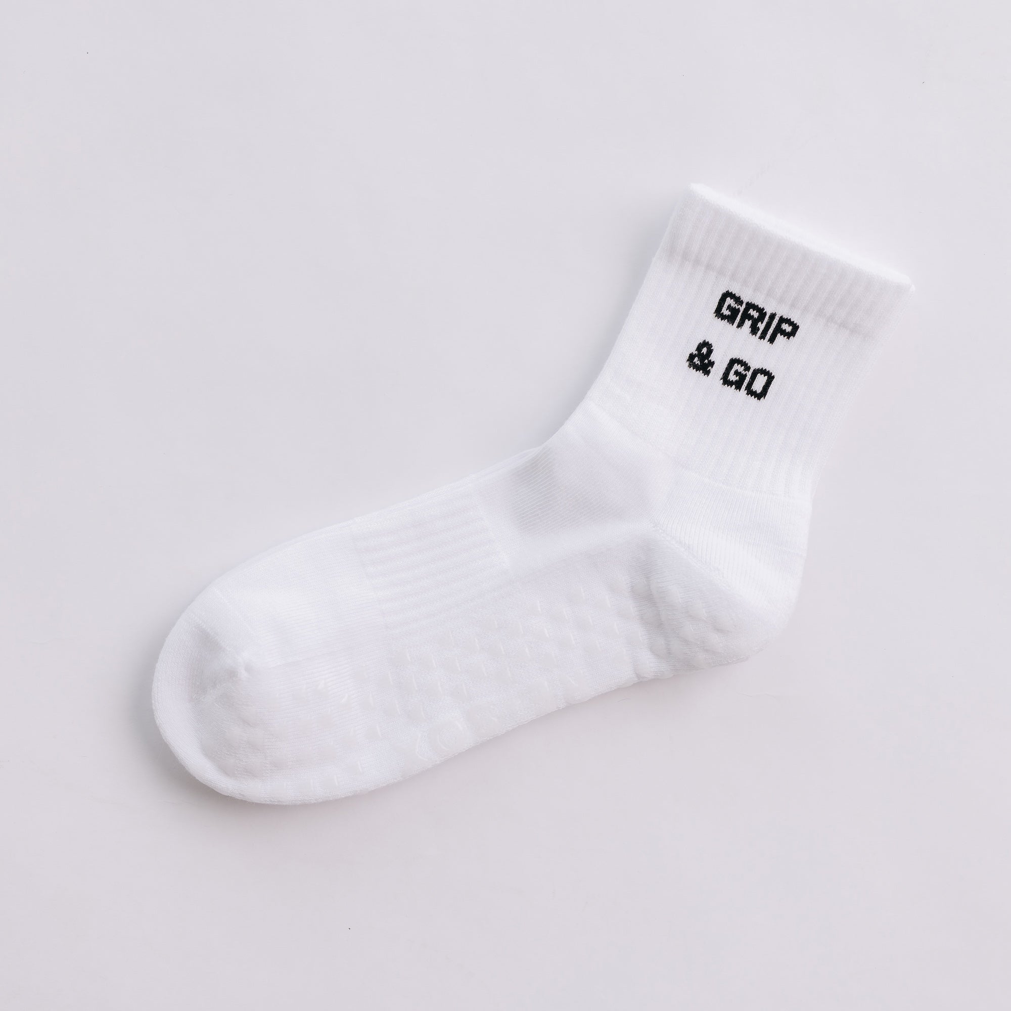 White  grip sock with 'Grip & Go' text on a light gray background